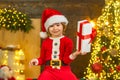 Happy cute child in Santa hat with present have a Christmas. Christmas kids. Christmas decorations. Little Santa Claus Royalty Free Stock Photo