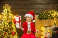 Happy cute child in Santa hat with present have a Christmas. Christmas kids. Christmas decorations. Little Santa Claus Royalty Free Stock Photo