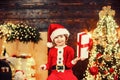 Happy cute child in Santa hat with present have a Christmas. Christmas kids. Christmas decorations. Little Santa Claus Royalty Free Stock Photo