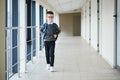 Happy cute clever boy in glasses with school bag and book in his hand. First time to school. Back to school. Royalty Free Stock Photo