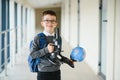 Happy cute clever boy in glasses with school bag and book in his hand. First time to school. Back to school. Royalty Free Stock Photo