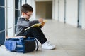 Happy cute clever boy in glasses with school bag and book in his hand. First time to school. Back to school Royalty Free Stock Photo