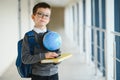 Happy cute clever boy in glasses with school bag and book in his hand. First time to school. Back to school Royalty Free Stock Photo