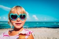 Happy cute girl eating ice cream on beach Royalty Free Stock Photo