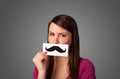 Happy cute girl holding paper with mustache drawing Royalty Free Stock Photo