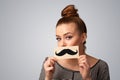 Happy cute girl holding paper with mustache drawing Royalty Free Stock Photo