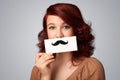 Happy cute girl holding paper with mustache drawing Royalty Free Stock Photo