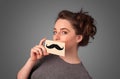 Happy cute girl holding paper with mustache drawing Royalty Free Stock Photo