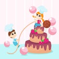 A happy cute girl holds a huge candy pop on a stick in her hands and sits on top of a huge cake. The boy comes up to her. Royalty Free Stock Photo