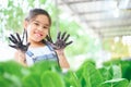 Happy cute girl with a raised hands couple picking vegetable from backyard garden Royalty Free Stock Photo