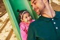 Happy cute kid daughter smiling and playing with her father outdoors. Handsome dad and toddler little girl laughing and having fun Royalty Free Stock Photo