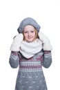 Happy cute kid posing in the studio isolated on white background. Wearing winter clothes. Knitted woolen sweater, scarf, hat. Royalty Free Stock Photo