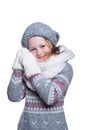 Happy cute kid posing in the studio isolated on white background. Wearing winter clothes. Knitted woolen sweater, scarf, hat. Royalty Free Stock Photo