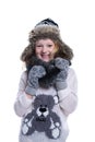 Happy cute kid posing in the studio. Wearing winter clothes. Knitted woolen sweater and mittens. Ear flaps fur cap. Royalty Free Stock Photo