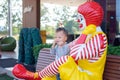 Happy cute little Asian toddler boy child play with Ronald McDonald