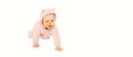 Happy cute little baby crawling in pink bathrobe on the floor on white background, banner blank copy space for advertising text Royalty Free Stock Photo