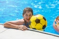 Happy cute little boy teenager in swimming pool. Active games on water, vacation, holidays concept. Chocolate donut. Royalty Free Stock Photo