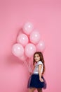 Child girl posing with pastel pink air balloons Royalty Free Stock Photo