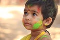 Happy cute little child on holi color festival.