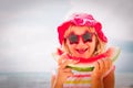 Happy cute little girl eating watermelon at beach Royalty Free Stock Photo