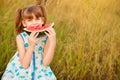 Happy cute little girl eating watermelon in summertime Royalty Free Stock Photo