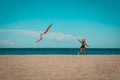 Happy cute little girl flying a kite on beach Royalty Free Stock Photo