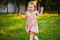 Happy cute little girl running on the grass in the park. Happiness Royalty Free Stock Photo