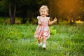 Happy cute little girl running on the grass in the park. Happiness. Royalty Free Stock Photo