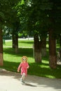 Happy cute little girl running in the park. Happiness. Royalty Free Stock Photo