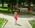 Happy cute little girl running in the park. Happiness. Royalty Free Stock Photo