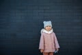 Happy cute little girl smiling against the dark wall Royalty Free Stock Photo