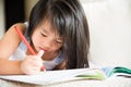 Happy cute little girl smiling and holding red pencil Royalty Free Stock Photo