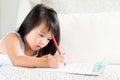 Happy cute little girl smiling and holding red pencil Royalty Free Stock Photo