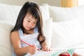 Happy cute little girl smiling and holding red pencil Royalty Free Stock Photo