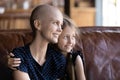 Happy cute little kid giving support to mom with cancer