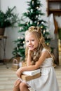 Happy cute little smiling girl with christmas gift box. Merry Christmas and Happy Holidays. Royalty Free Stock Photo