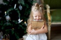 Happy cute little smiling girl with christmas gift box. Merry Christmas and Happy Holidays. Royalty Free Stock Photo