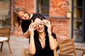 Happy cute lovely little girl is covering her mother& x27;s eyes with her palms. Royalty Free Stock Photo