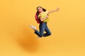 Happy preteen girl with backpack and books jumping up Royalty Free Stock Photo