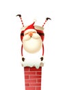 Happy cute Santa Claus standing on hands on the chimney - isolated on white background