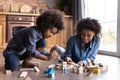 Happy cute small African American child playing toys with mum. Royalty Free Stock Photo