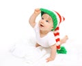 Happy cute smiling baby in knitted hat crawls on white