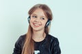 Happy cute smiling kid girl listening to music in her headphones Royalty Free Stock Photo