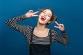Happy cute young woman showing peace sign Royalty Free Stock Photo