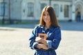 Happy cute young woman student holding books and walking Royalty Free Stock Photo