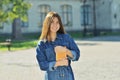 Happy cute young woman student holding books and walking Royalty Free Stock Photo