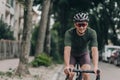 Happy cyclist riding black bike on city street