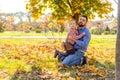 Happy dad with daughter at sunset walking in the park in autumn