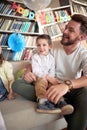 A happy Dad enjoys a kids birthday party at home with his children. Family, celebration, together Royalty Free Stock Photo