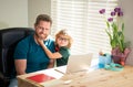 happy dad helping his school son child in glasses study with computer at home, education Royalty Free Stock Photo